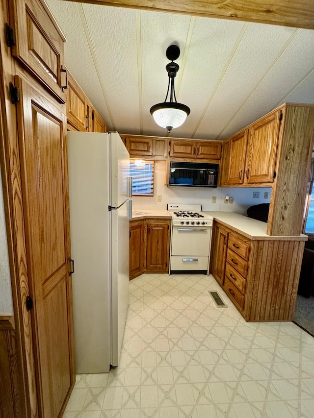 15827 Wilderness Trl Unit 28, Crosslake, MN 56442 - kitchen featuring white appliances, light flooring, brown cabinets, and light countertops
