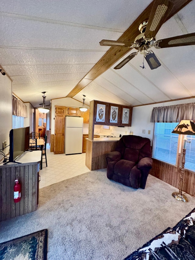 15827 Wilderness Trl Unit 28, Crosslake, MN 56442 - living area with vaulted ceiling, a ceiling fan, light colored carpet, wooden walls, and light floors