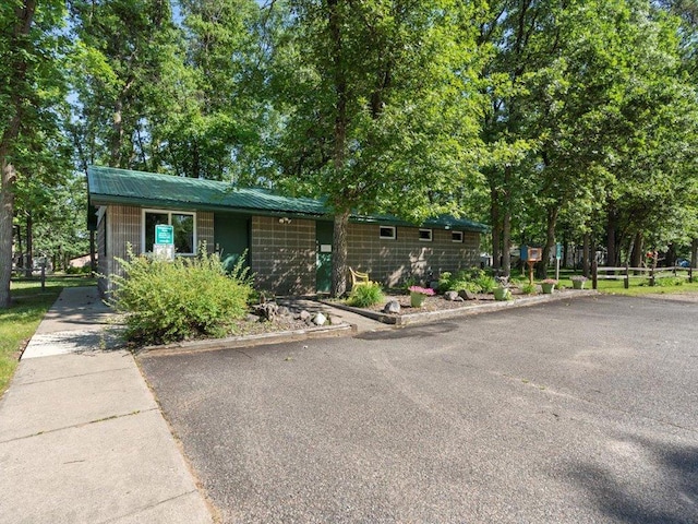 15827 Wilderness Trl Unit 28, Crosslake, MN 56442 - view of front facade featuring driveway and a metal roof