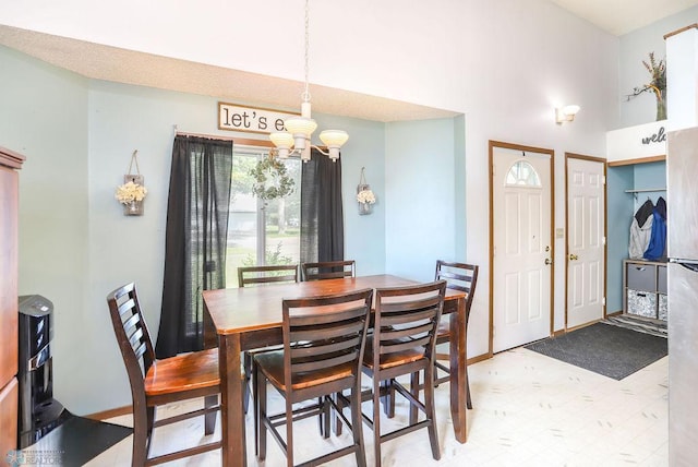 1426 11th St W, West Fargo, ND 58078 - dining space featuring a chandelier, a high ceiling, and light floors