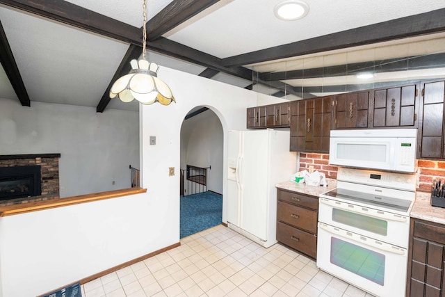 1290 Polk Pl, Columbia Heights, MN 55421 - kitchen with white appliances, light countertops, dark brown cabinets, arched walkways, and a glass covered fireplace
