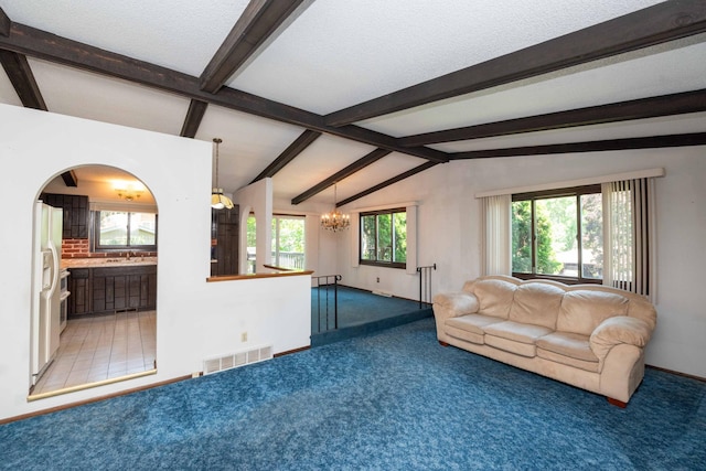 1290 Polk Pl, Columbia Heights, MN 55421 - unfurnished living room with a chandelier, light colored carpet, and plenty of natural light