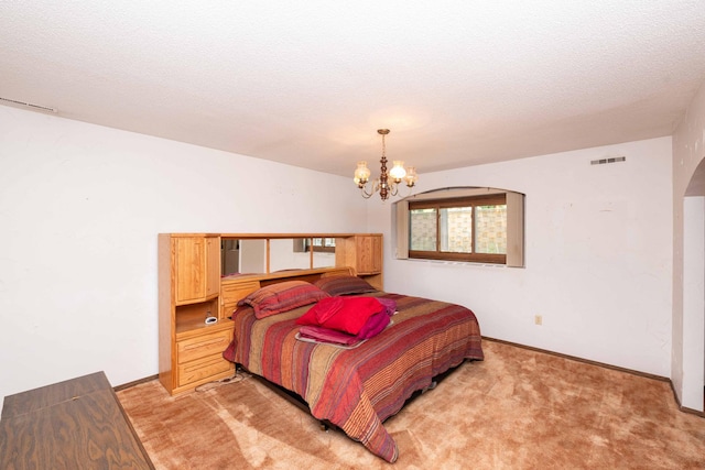1290 Polk Pl, Columbia Heights, MN 55421 - bedroom with a chandelier, light carpet, and arched walkways
