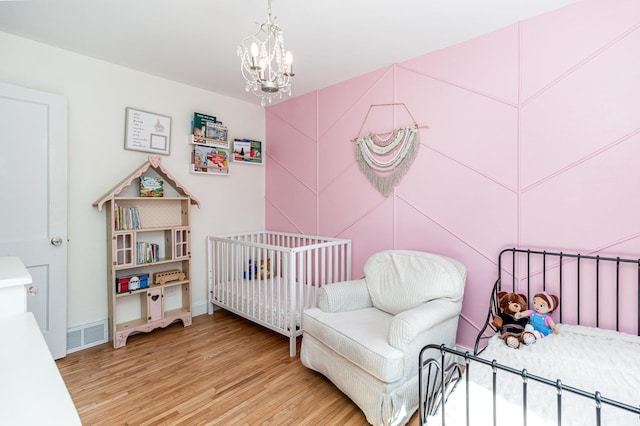 1034 Carroll Ave, Saint Paul, MN 55104 - bedroom with light wood finished floors and a chandelier