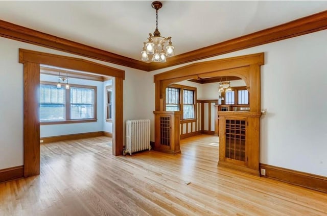4105 Columbus Ave, Minneapolis, MN 55407 - empty room featuring a chandelier, radiator heating unit, wood finished floors, and healthy amount of natural light