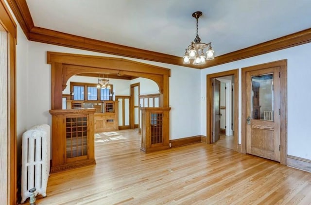 4105 Columbus Ave, Minneapolis, MN 55407 - spare room with a chandelier, radiator heating unit, ornamental molding, light wood-style floors, and french doors