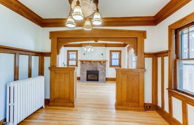 4105 Columbus Ave, Minneapolis, MN 55407 - hallway with a chandelier, radiator, healthy amount of natural light, ornamental molding, and light wood finished floors