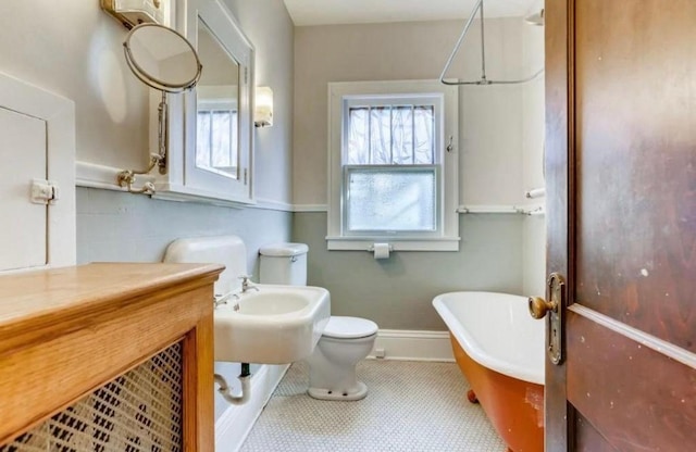 4105 Columbus Ave, Minneapolis, MN 55407 - full bathroom featuring a freestanding tub and toilet