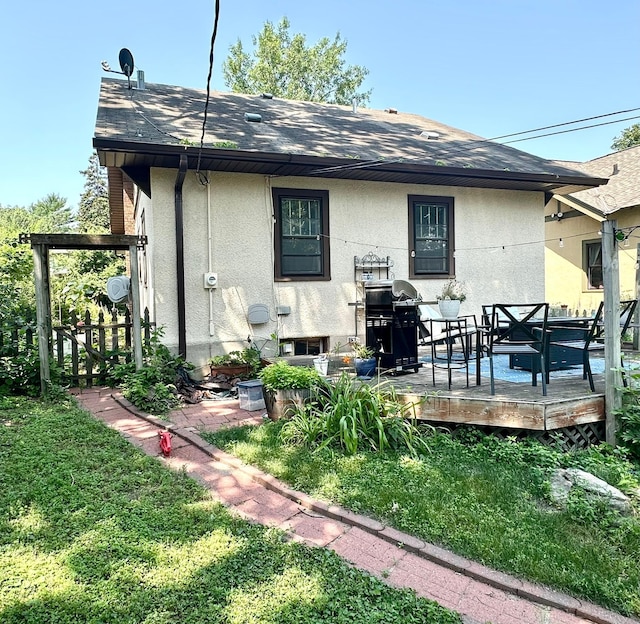 4105 Columbus Ave, Minneapolis, MN 55407 - back of property featuring stucco siding, a shingled roof, and a deck