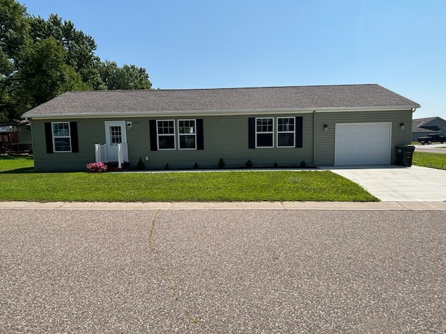 675 Brooks St S, Eden Valley, MN 55329 - ranch-style house with concrete driveway, a front lawn, and an attached garage