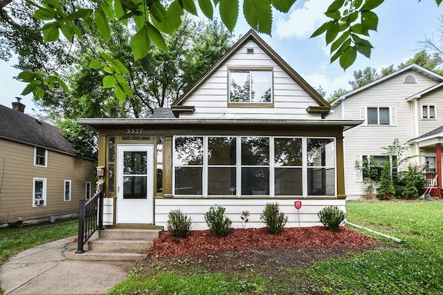 3339 Aldrich Ave N, Minneapolis, MN 55412 - view of front of house featuring a sunroom and a front yard