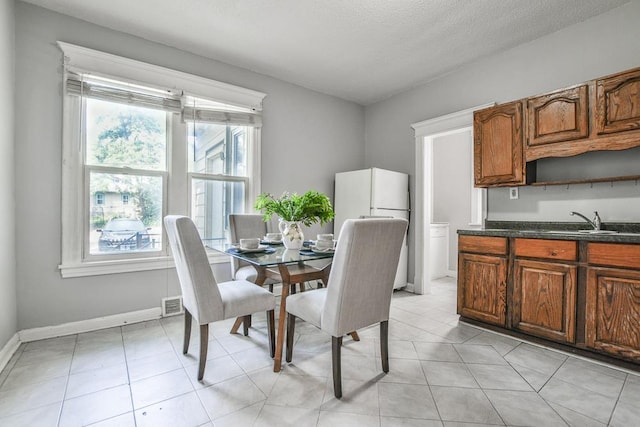 3339 Aldrich Ave N, Minneapolis, MN 55412 - dining room featuring baseboards and light tile patterned floors