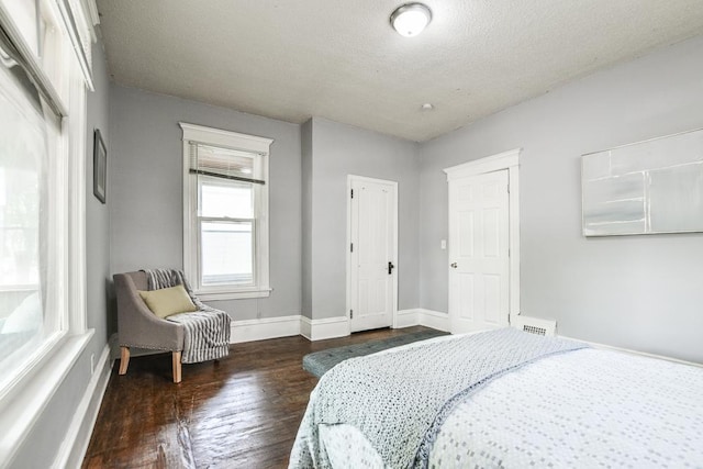 3339 Aldrich Ave N, Minneapolis, MN 55412 - bedroom featuring dark wood finished floors and a textured ceiling