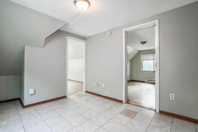 3339 Aldrich Ave N, Minneapolis, MN 55412 - bonus room featuring a textured ceiling, a baseboard heating unit, and vaulted ceiling
