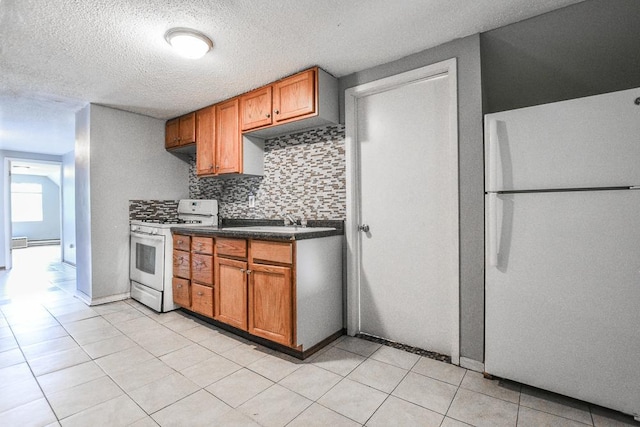3339 Aldrich Ave N, Minneapolis, MN 55412 - kitchen featuring white appliances, backsplash, dark countertops, brown cabinetry, and a textured ceiling