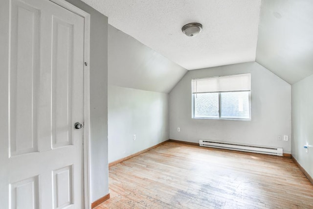 3339 Aldrich Ave N, Minneapolis, MN 55412 - bonus room featuring baseboard heating, hardwood / wood-style flooring, vaulted ceiling, and a textured ceiling