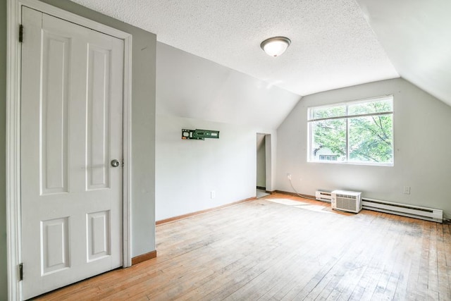 3339 Aldrich Ave N, Minneapolis, MN 55412 - bonus room with a baseboard radiator, wood-type flooring, lofted ceiling, and a textured ceiling