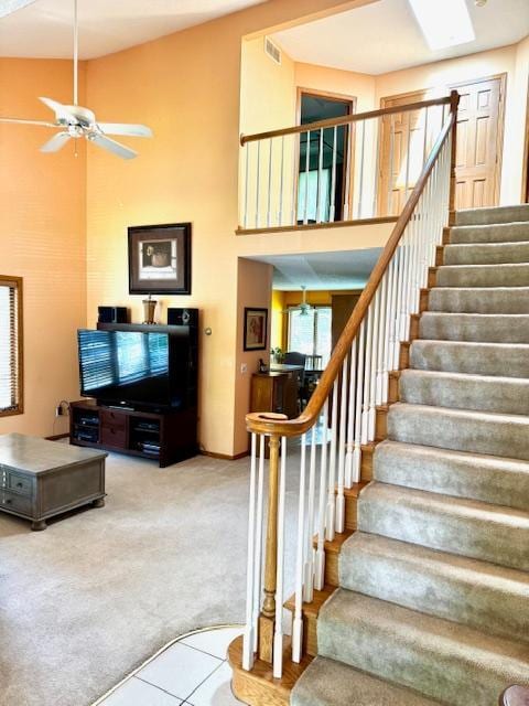 14886 Crandall Ave W, Rosemount, MN 55068 - staircase featuring a high ceiling, a ceiling fan, carpet floors, and tile patterned flooring