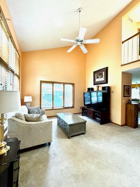14886 Crandall Ave W, Rosemount, MN 55068 - carpeted living room featuring high vaulted ceiling and ceiling fan