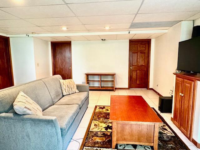 14886 Crandall Ave W, Rosemount, MN 55068 - living area featuring light tile patterned floors and a paneled ceiling