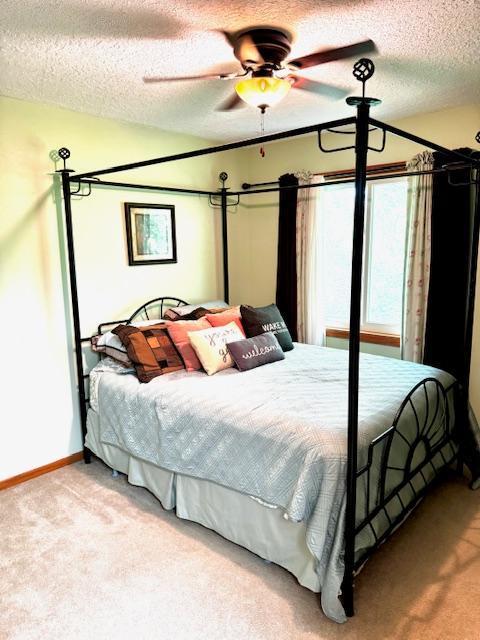 14886 Crandall Ave W, Rosemount, MN 55068 - bedroom featuring carpet flooring, a textured ceiling, and a ceiling fan