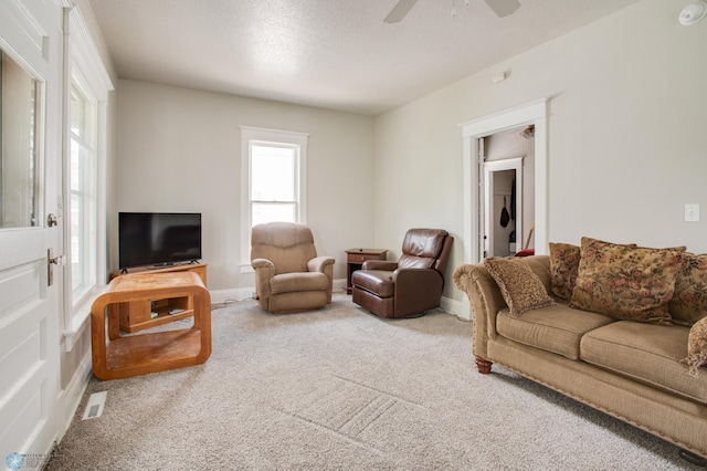 1137 11th St N, Fargo, ND 58102 - living area featuring a ceiling fan, carpet flooring, and a textured ceiling