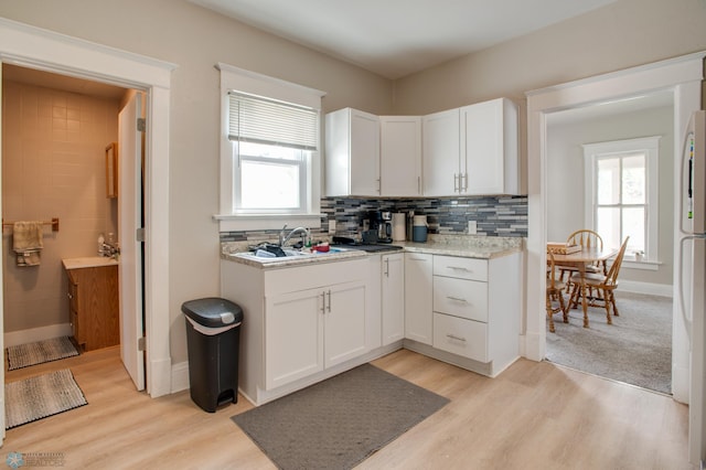 1137 11th St N, Fargo, ND 58102 - kitchen featuring healthy amount of natural light, light wood-style floors, and white cabinets