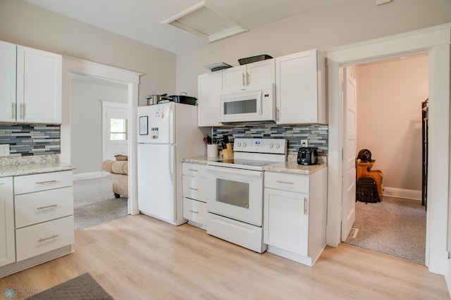 1137 11th St N, Fargo, ND 58102 - kitchen with white appliances, light wood-style flooring, backsplash, and white cabinets