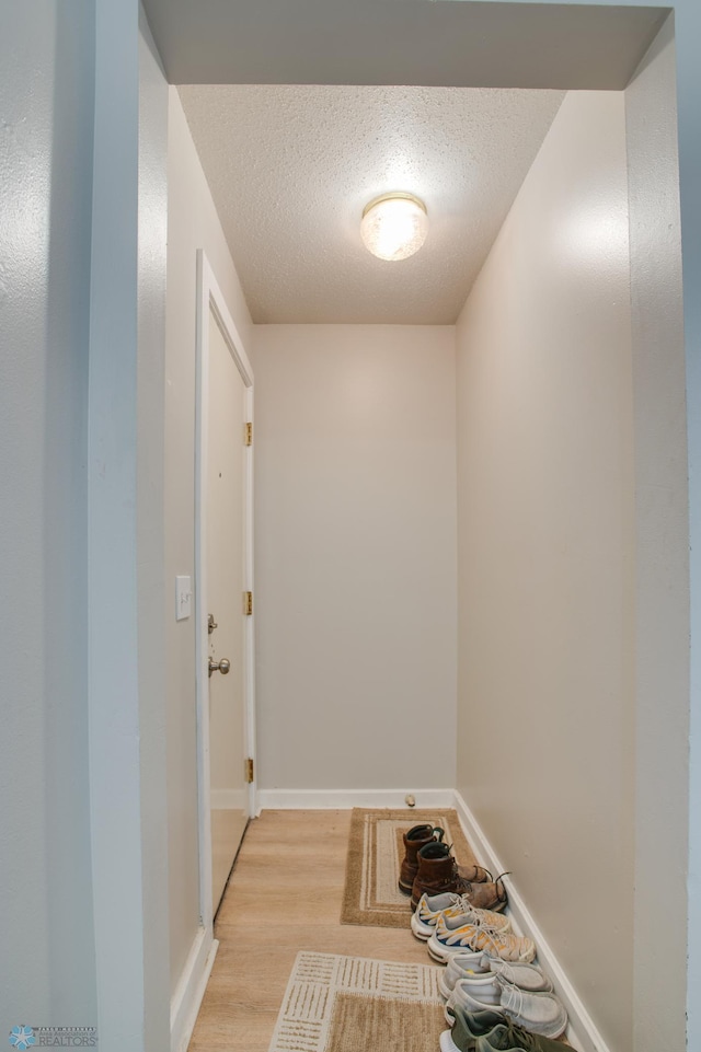 1137 11th St N, Fargo, ND 58102 - corridor featuring light wood finished floors and a textured ceiling