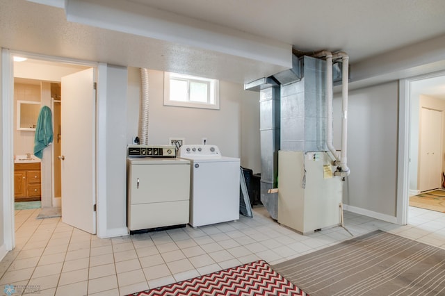 1137 11th St N, Fargo, ND 58102 - laundry area with washer and dryer, heating unit, and light tile patterned floors
