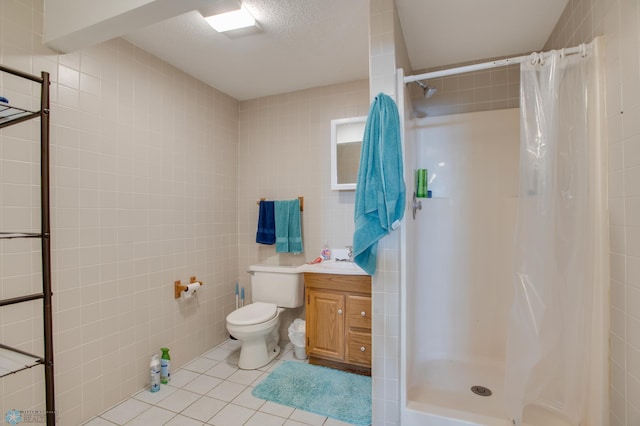 1137 11th St N, Fargo, ND 58102 - full bathroom featuring tile walls, tile patterned floors, a stall shower, and vanity