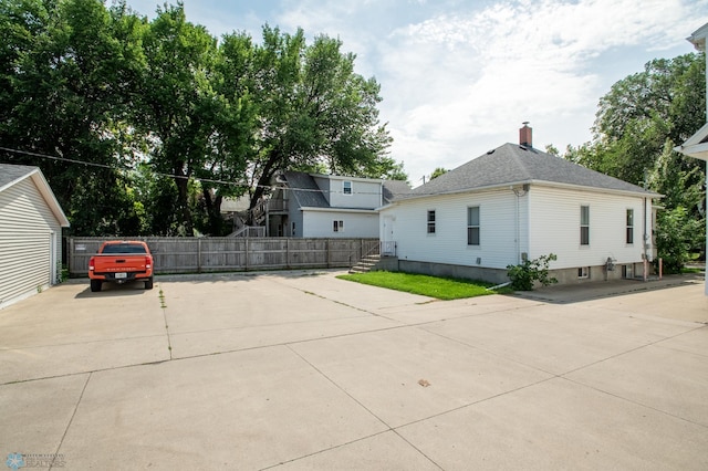 1137 11th St N, Fargo, ND 58102 - view of side of property with concrete driveway and a chimney