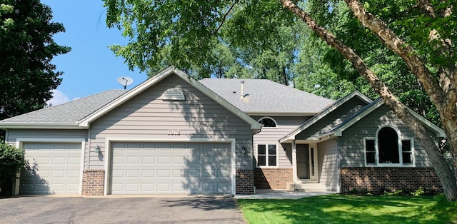 1312 Fremont Ct, Burnsville, MN 55306 - view of front of property featuring brick siding, a garage, driveway, and roof with shingles