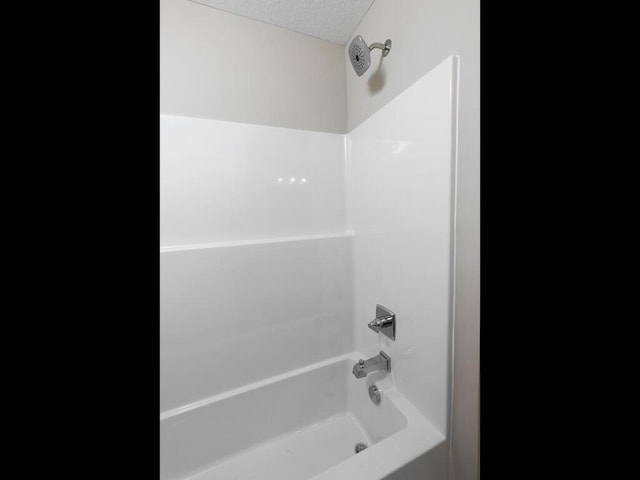 6711 Granby St, North Branch, MN 55056 - full bathroom featuring a textured ceiling and bathing tub / shower combination