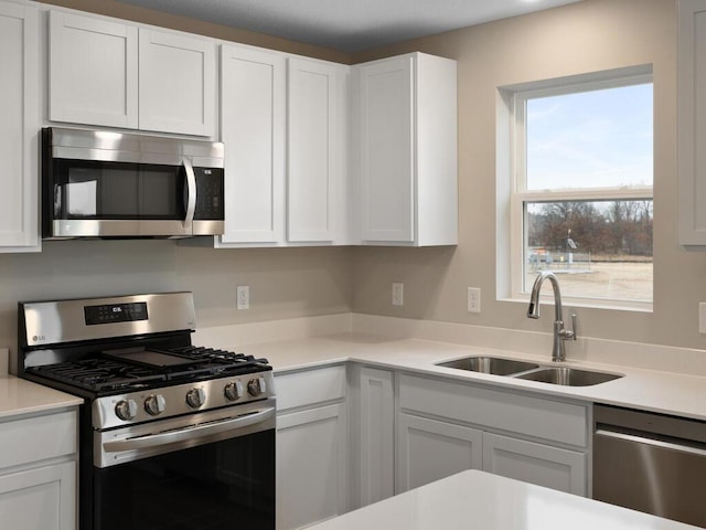 6711 Granby St, North Branch, MN 55056 - kitchen featuring stainless steel appliances, light countertops, and white cabinets