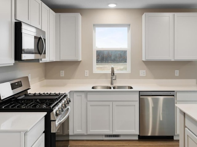 6711 Granby St, North Branch, MN 55056 - kitchen featuring appliances with stainless steel finishes, white cabinetry, and light countertops