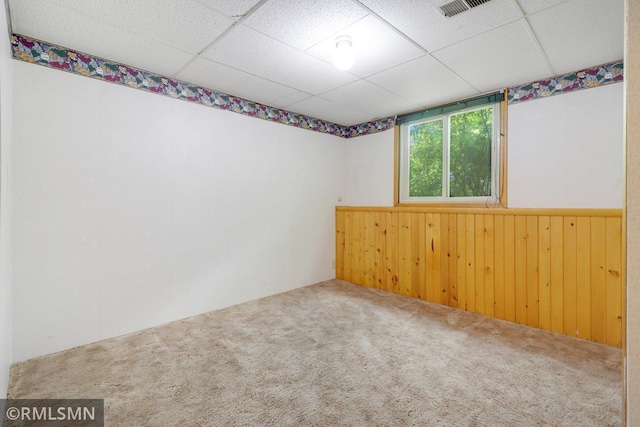 5733 Riverview Entry, Champlin, MN 55316 - spare room featuring carpet, a drop ceiling, wooden walls, and a wainscoted wall