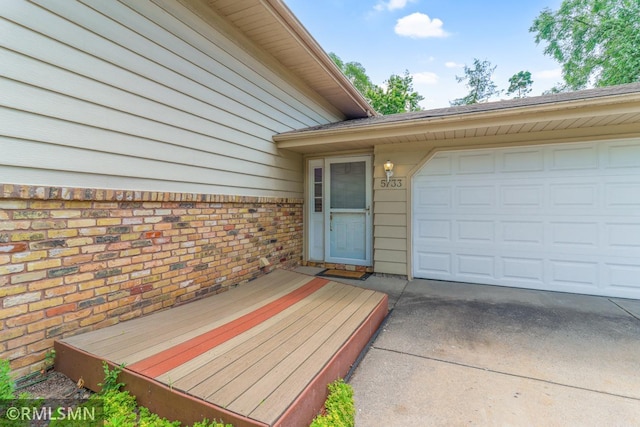 5733 Riverview Entry, Champlin, MN 55316 - entrance to property featuring a garage and driveway