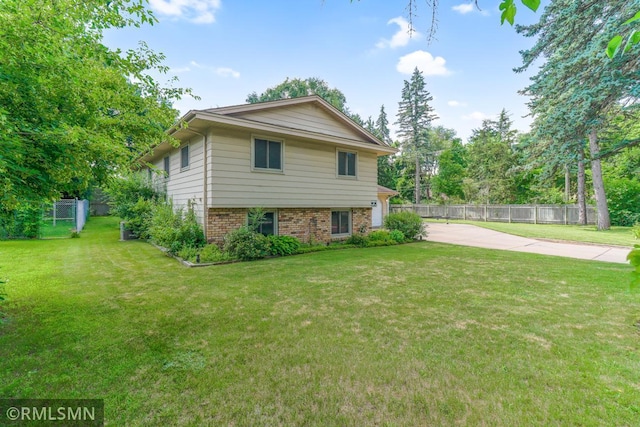 5733 Riverview Entry, Champlin, MN 55316 - view of home's exterior with driveway and brick siding