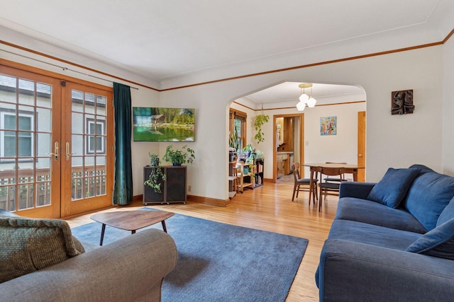3607 Sheridan Ave N, Minneapolis, MN 55412 - living area with arched walkways, wood finished floors, healthy amount of natural light, crown molding, and french doors