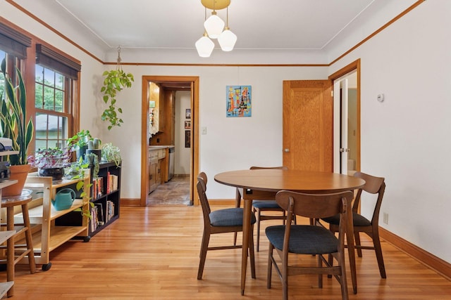 3607 Sheridan Ave N, Minneapolis, MN 55412 - dining space with light wood-type flooring and crown molding