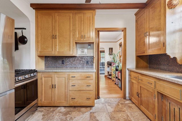 3607 Sheridan Ave N, Minneapolis, MN 55412 - kitchen with gas range, freestanding refrigerator, decorative backsplash, crown molding, and light stone finish floors