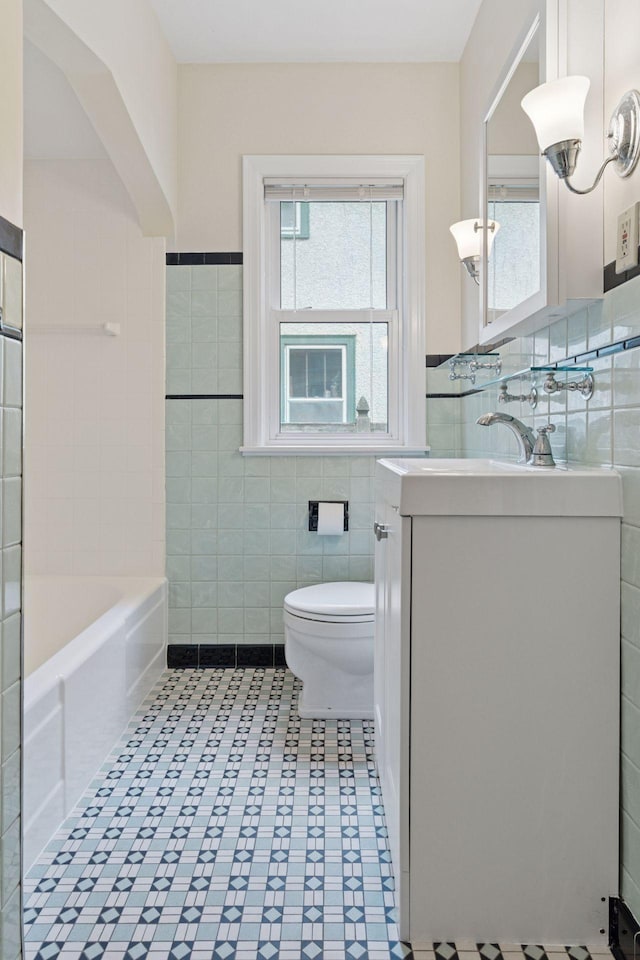 3607 Sheridan Ave N, Minneapolis, MN 55412 - bathroom featuring tile walls, vanity, a bath, tile patterned floors, and wainscoting
