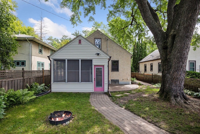 3607 Sheridan Ave N, Minneapolis, MN 55412 - rear view of property with a fenced backyard, an outdoor fire pit, a sunroom, and a patio area