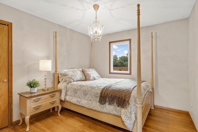 6700 168th St W, Lakeville, MN 55068 - bedroom with light wood-style floors and a chandelier