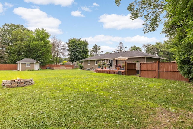 6700 168th St W, Lakeville, MN 55068 - fenced backyard featuring a fire pit, a deck, and a storage unit