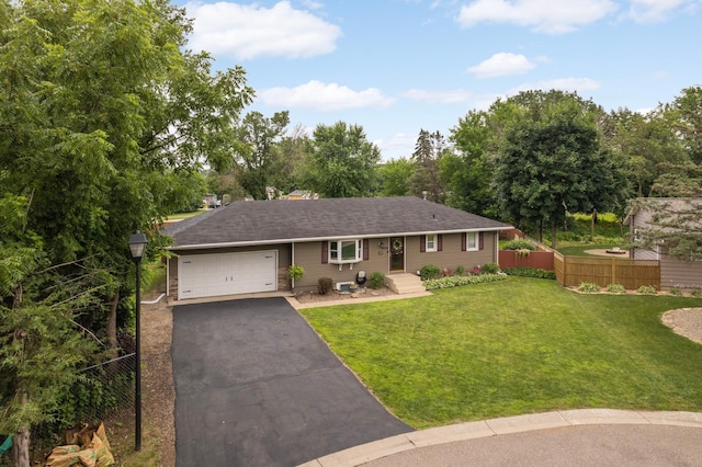 6700 168th St W, Lakeville, MN 55068 - ranch-style home featuring asphalt driveway, a garage, and view of wooded area