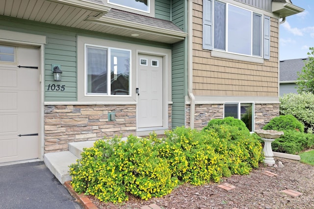 1035 Emerald St NE, Hanover, MN 55341 - doorway to property featuring stone siding and a garage