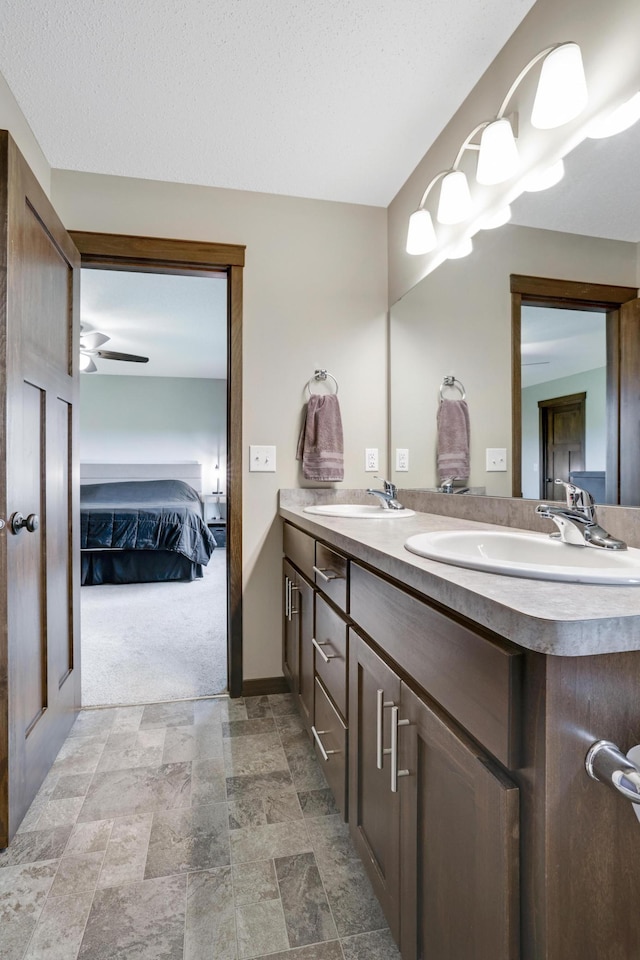 1035 Emerald St NE, Hanover, MN 55341 - ensuite bathroom featuring double vanity, stone finish flooring, and ceiling fan
