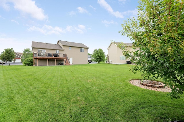 1035 Emerald St NE, Hanover, MN 55341 - view of green lawn featuring a deck, stairs, and a fire pit